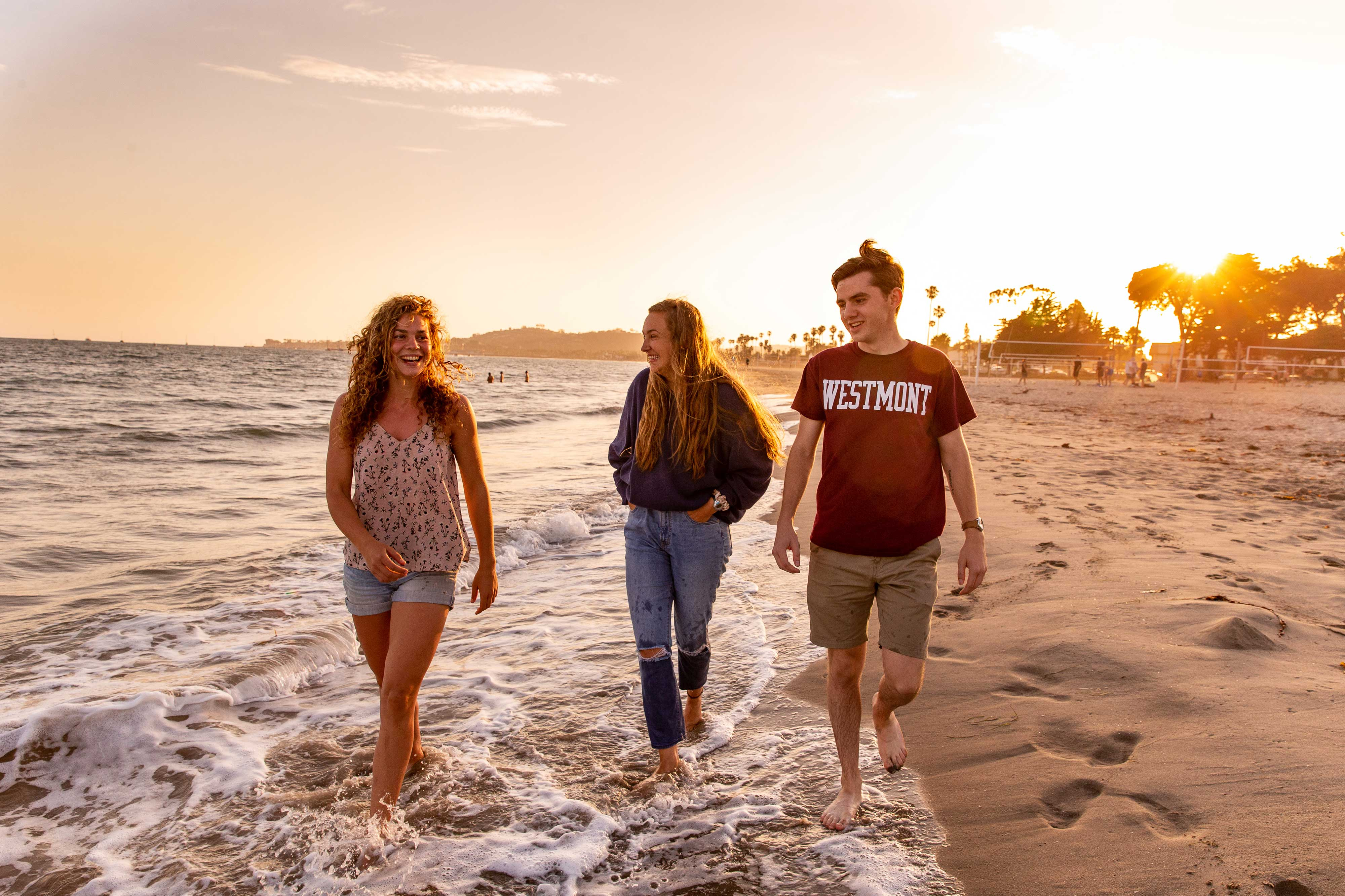 westmont students walking on beach sunset