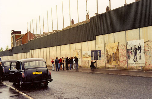 Westmont students read and sign the 'peace wall' in Belfast, Northern Ireland
