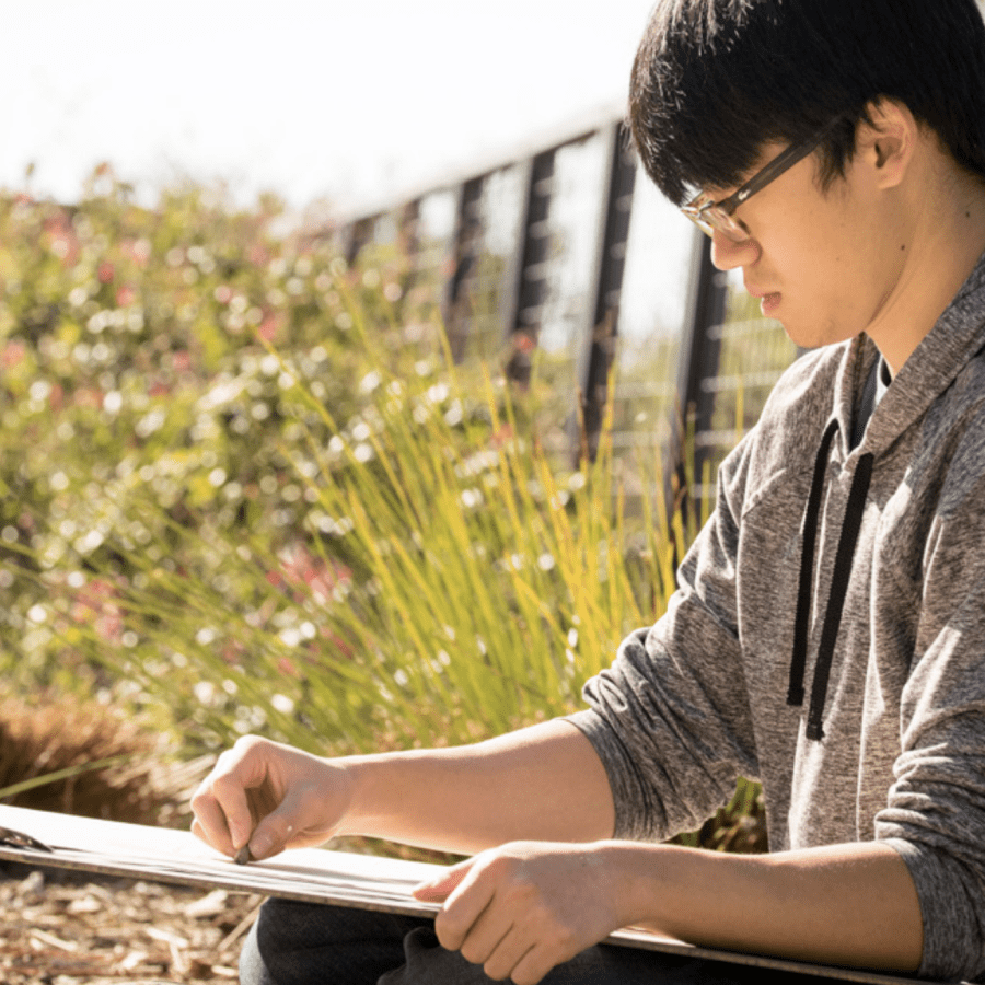 male art student drawing outside