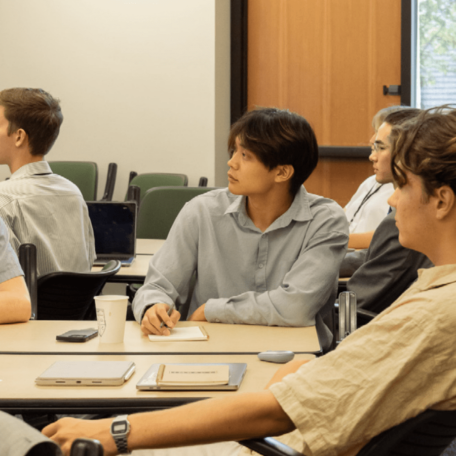 male students westmont in class listening