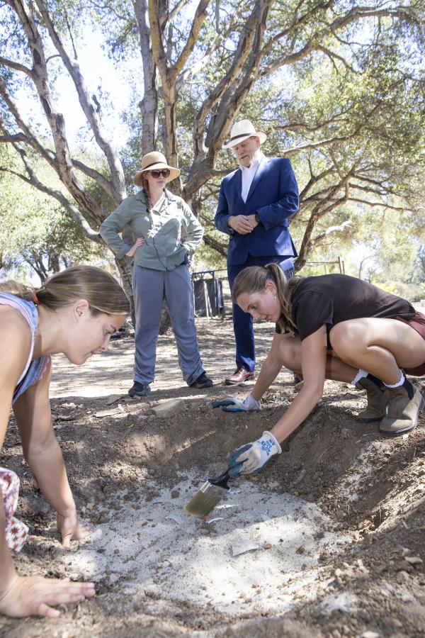 Sara Morrisset and Gayle D. Beebe stand at the dig site