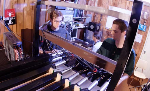 Students Evan and Shea Mosby work with Professor Warren Rogers (background) on the Westmont Cosmic Muon Detector Array, which was destroyed in the Tea Fire