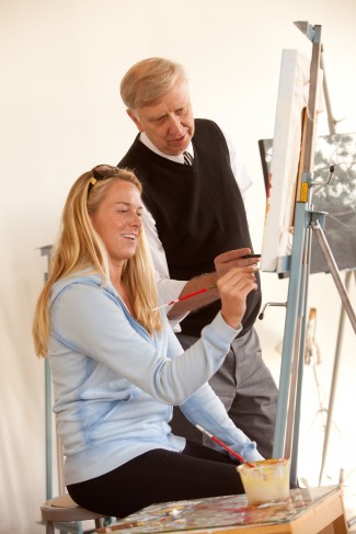 Senior Hillary Dunks paints with art professor John Carlander