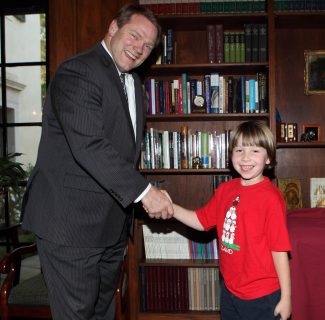 6-year-old Liam Hess greets President Gayle D. Beebe after making an historic donation