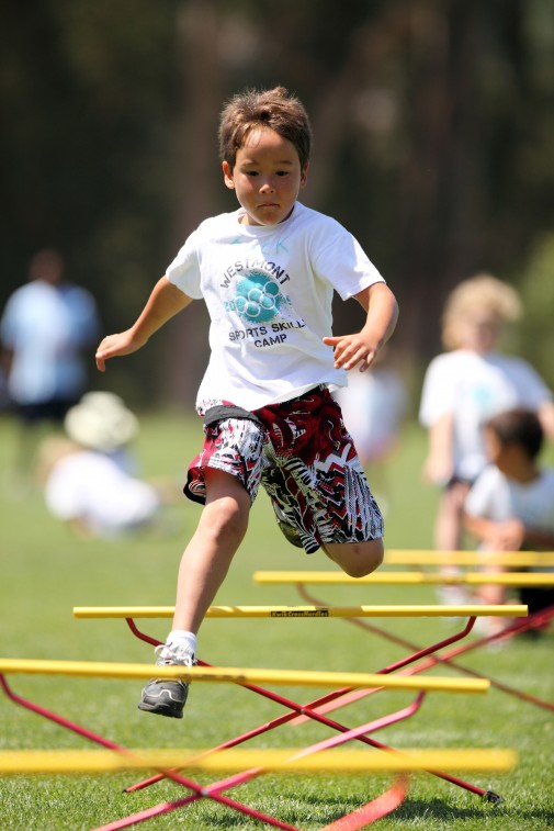 Camper Jack Turner flies over hurdles during Sports Skills camp that begins June 13