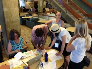 Debra Quast (left), library director, gives Team Northridge another clue after it successfully completed a roadblock