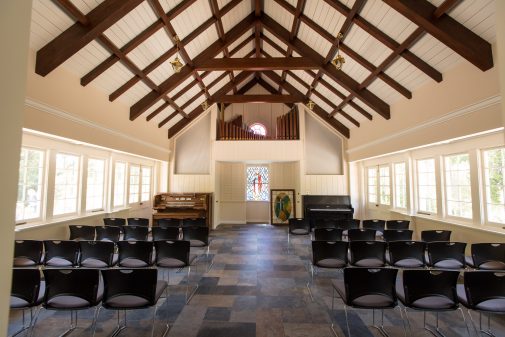 Warm light basks in the renovated prayer chapel. These temporary chairs will be replaced with wood-framed, fabric-covered chairs 