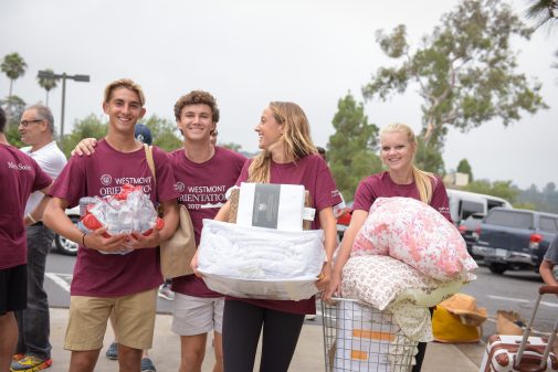 Student volunteers unload cars and move new students into their residence halls
