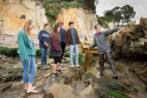 Beth Horvath with students in tide pools near Ledbetter Beach