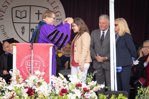 President Beebe offers the Westmont Medal to Katherine Wiebe and Lindsay and Laurie Parton