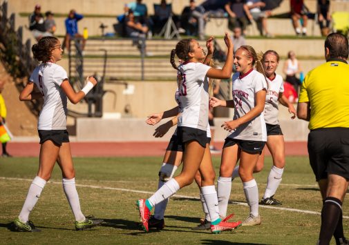 Sophomore forward Katie Stella (left #9) is congratulated after scoring the winning goal Nov. 23
