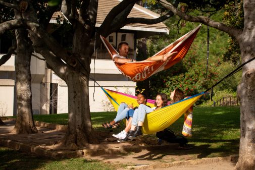 Westmont students enjoy hanging in hammocks on the Magnolia lawn in front of Voskuyl Library