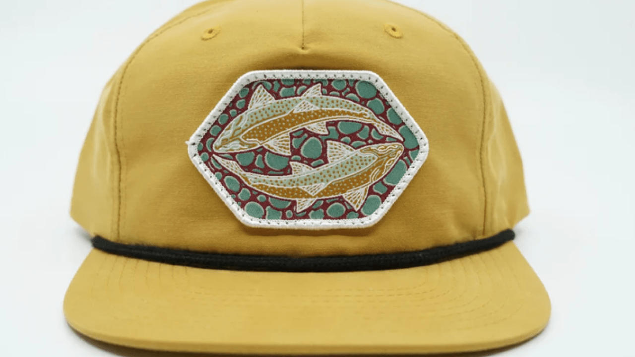 Yellow hat with fish patch on it.