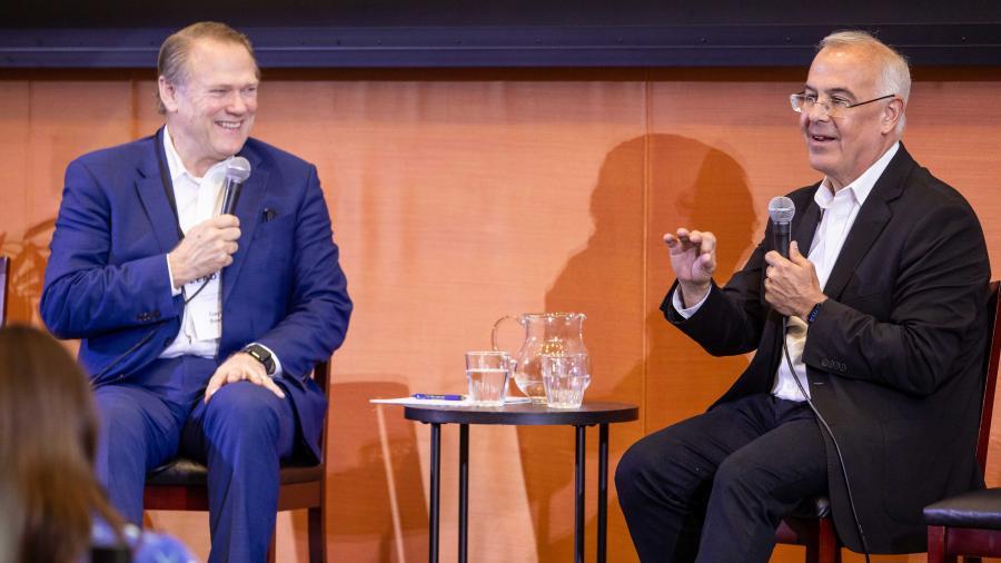 Gayle D. Beebe and David Brooks share a laugh at the 10th annual Lead Where You Stand Conference