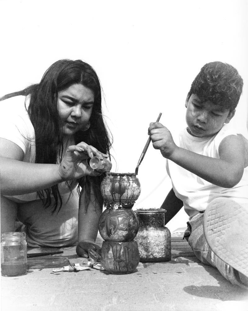 photo of two figures with pots